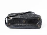 black leather handbag on a white background with a strap