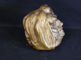 statue of a woman ' s head with long hair on a black background