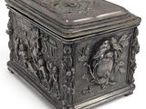 an antique silver box with a design of people and animals on it