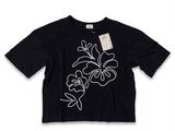 a black t - shirt with white flowers on it