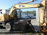 a yellow excavator that is sitting in the dirt