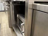 stainless steel ovens and microwaves in a commercial kitchen