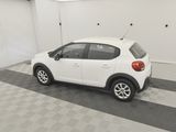 the small white car is parked in the garage on the checkered floor