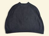 a picture of a black sweater hanging on a hanger