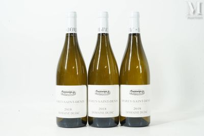three bottles of wine sitting on top of a white table