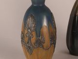 two vases sitting next to each other on a table