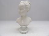 a small white bust of a child on a glass stand