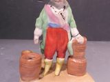 a figurine of a man sitting on a rock