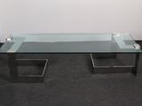 a glass coffee table with metal legs and a glass top