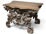 a wooden table with carvings on it on a white background
