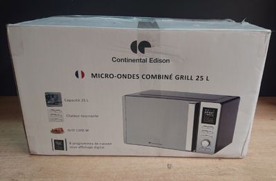 packaging of a microwave sitting on top of a wooden table