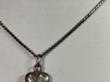 necklace with a silver heart on a chain on a mannequin
