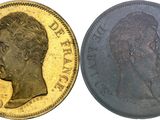 two gold sovereigns, one of which has a head of a man and the other of which is a