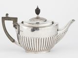 une théière ancienne en argent, avec un couvercle et une anse