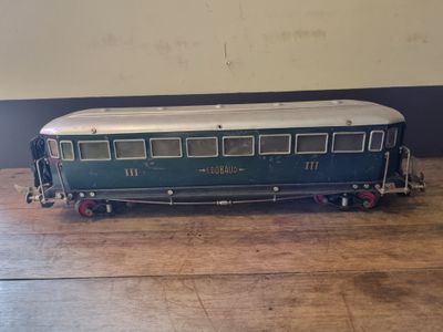 a blue and white train car on a wooden table