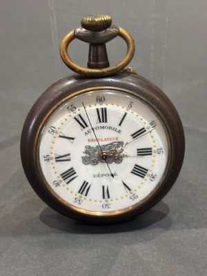 a small clock with roman numerals on the face