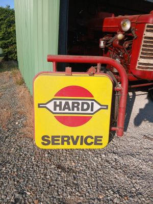 a sign that says hard service on the side of the road
