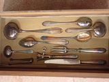 a lot of silver spoons and spoon spoons in a box