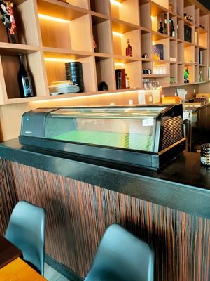 une photo d'un restaurant avec un comptoir et des chaises