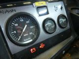 a close up of a car dashboard with a speedometer and gauges