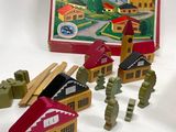 a toy set with a picture of a building and a toy soldier