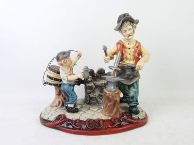 a figurine of a man and a boy working on a machine