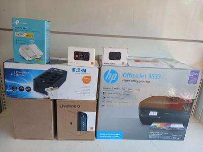 many boxes on the shelf of a store with a printer on it