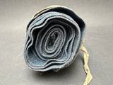 rolled up rolled up blue jeans on a gray surface