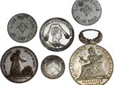 several different types of coins are shown on a white surface