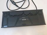 an image of a computer keyboard with a cord attached to it