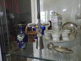 a glass display case with a lot of glass items on it