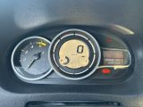 a close up of a car dashboard with a clock and gauges