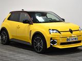 the yellow car is parked in a room with a checkered floor