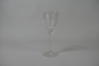 an empty wine glass sitting on top of a white table