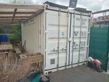 a large white container sitting in the middle of a yard