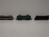 three toy trains sitting on a white surface next to each other