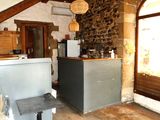 an image of a kitchen with a refrigerator and a table