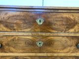 a wooden chest of drawers with brass knobs on it