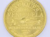 a close up of a gold coin on a white surface