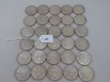 some silver coins are on a white surface with a price tag