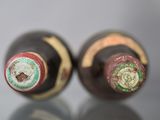 two bottles of wine that are sitting on a table