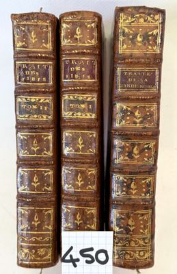 three old books are stacked on top of each other on a table