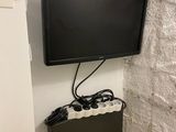 a flat screen tv mounted on the wall in the corner of a room