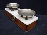 two metal bowls on a marble stand
