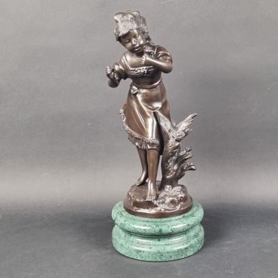 bronze figurine of a woman playing the flute