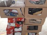 many boxes of clothing on a pallet in a warehouse