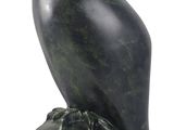 an image of a statue of an owl sitting on a rock