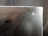 a broken laptop computer sitting on a table in a room