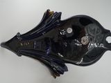 an image of a black fish shaped object on a white surface