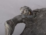 a statue of a woman laying on top of a statue